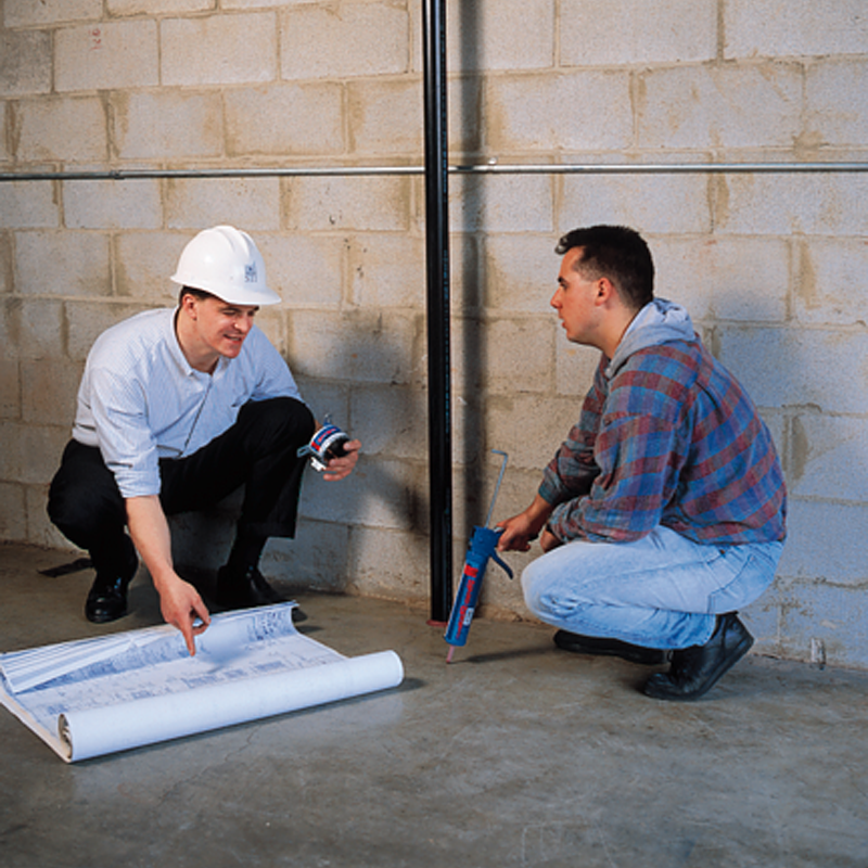 Two Guys talking over blueprints